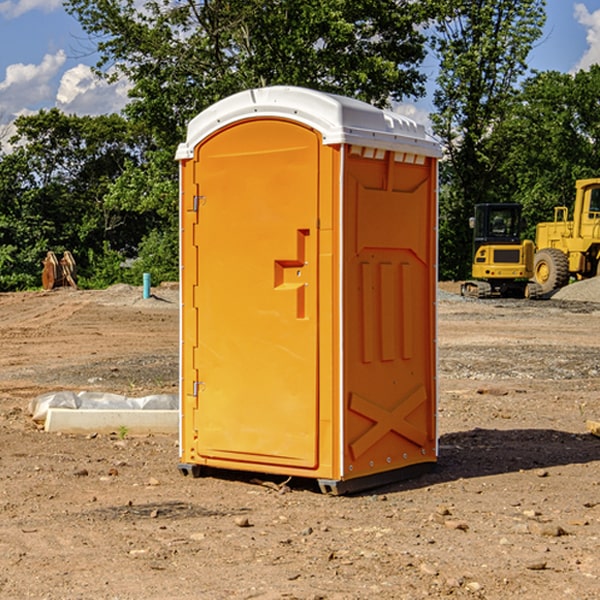 what is the cost difference between standard and deluxe portable restroom rentals in Grainfield